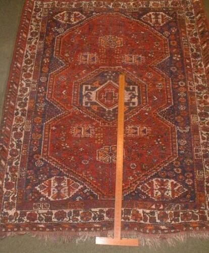 A red ground Persian rug 6'8" x 5'6"