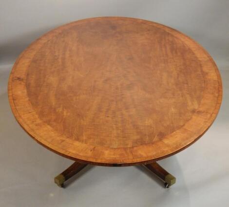 A mahogany oval dining table in Regency style