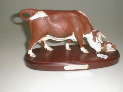 A Beswick/Royal Doulton figure No. A2667/2669 Hereford cow and calf