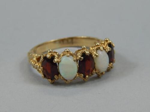A ladies opal and garnet dress ring