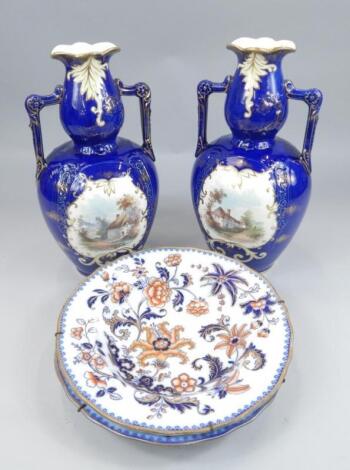 A pair of late 19thC Staffordshire pottery two handled vases
