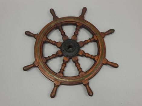 A teak brass and iron ship's wheel