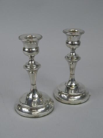 A pair of George V silver candlesticks