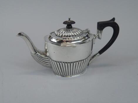 A silver part fluted tea for two sized teapot