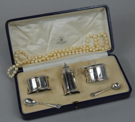 An Art Deco period George V silver three piece cruet