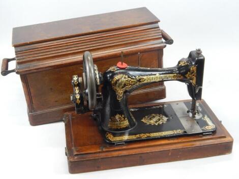 A Singer sewing machine in a walnut case