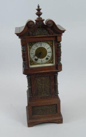 A miniature oak Continental longcase clock