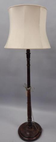 A turned and stained beech standard lamp