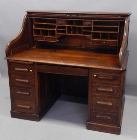 An early 20thC oak roll top desk