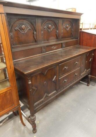 A 20thC stained oak sideboard