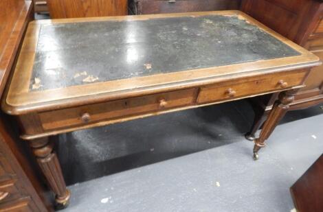 A Victorian oak writing table