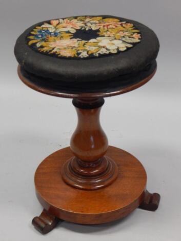 A Victorian mahogany revolving piano stool