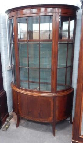 An Edwardian mahogany demi lune shaped display cabinet