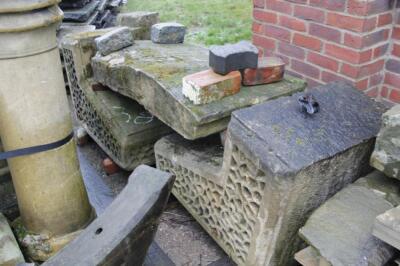 A pair of ornate sandstone arch supports