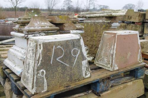 A quantity of red sandstone pillar bases and keystones.