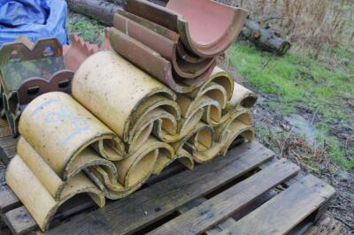 A quantity of earthenware buff roof ridges.