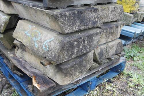 A quantity of sandstone gable end corbels.