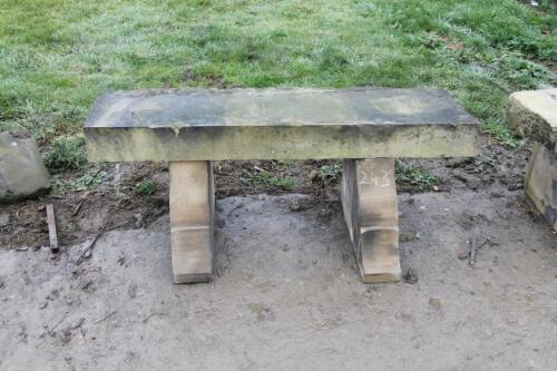 A rustic sandstone bench