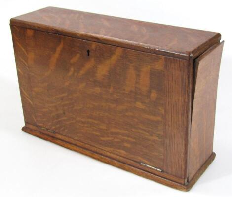 An Edwardian oak stationery cabinet