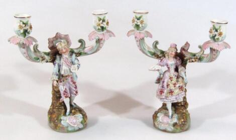 A pair of early 20thC Dresden style Continental porcelain candlesticks