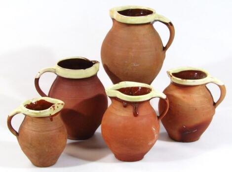 A set of five early 20thC red stoneware West Country cider jugs