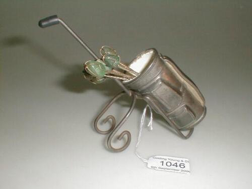 An early 20thC pewter golf bag and trolley with associated aventurine stone lobster forks