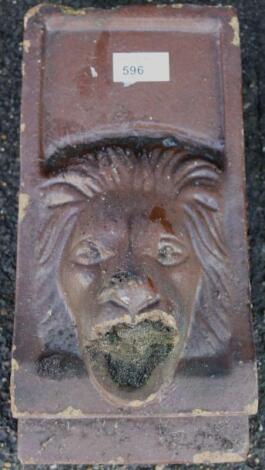 A clay baked garden wall mask fountain head