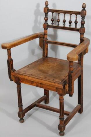 An Edwardian oak framed armchair