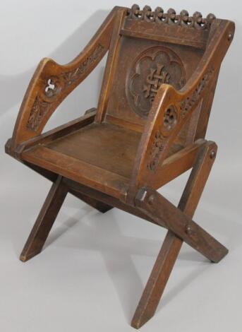 A late 19thC oak Gothic style Glastonbury chair