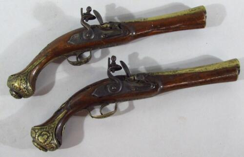 A pair of replica brass and walnut flint lock pistols