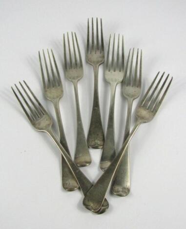 A composite set of seven crested Georgian/William IV silver dinner forks