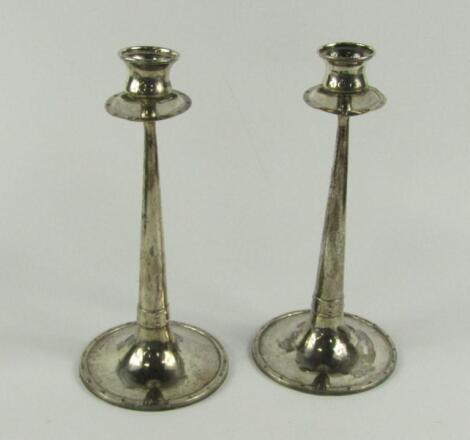 A pair of silver Arts & Crafts candlesticks