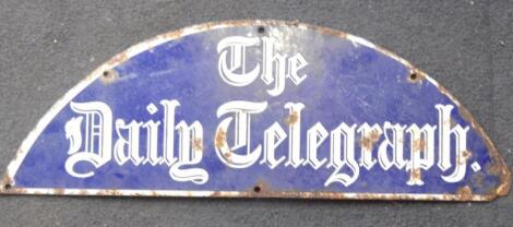 A demi-lune enamel sign for The Daily Telegraph