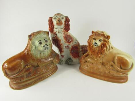 Two Scottish pottery fireside figures of recumbent lions