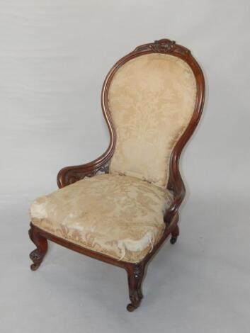 A Victorian walnut balloon back nursing chair