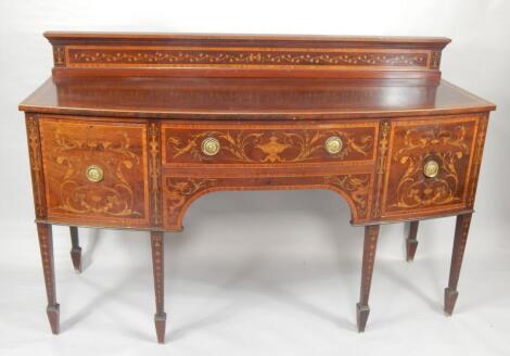 An Edwardian Hepplewhite style mahogany and inlaid bow front sideboard