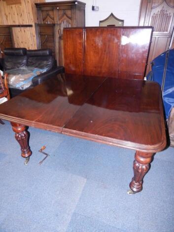 A Victorian mahogany wind-out dining table