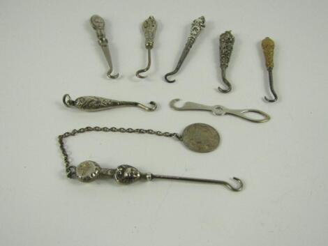 Eight small button hooks