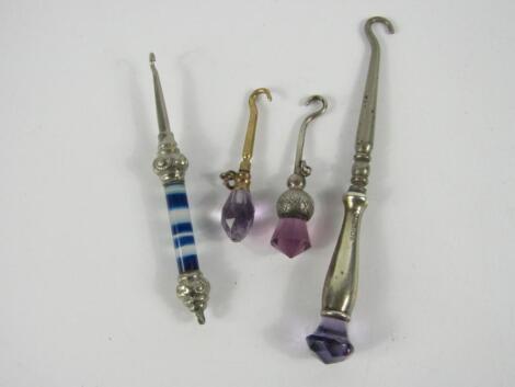 A miniature silver thistle button hook