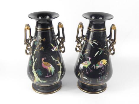 A pair of late 19thC black glazed pottery vases