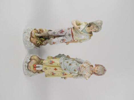 A pair of Rudolstadt late 19thC porcelain figural spill vases