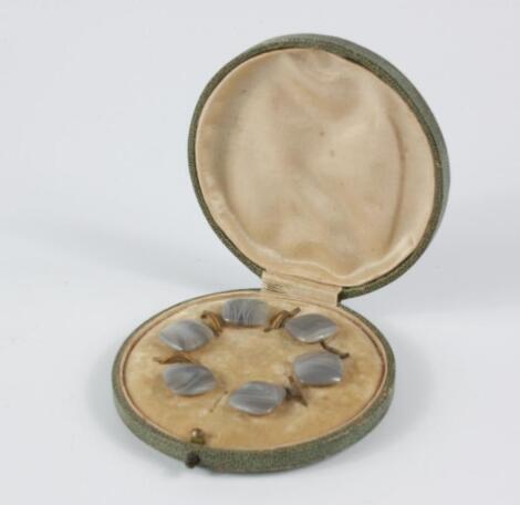 A set of Edwardian grey agate dress studs in a fitted case.