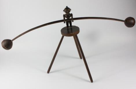 An early 20thC novelty turned wooden balancing figure