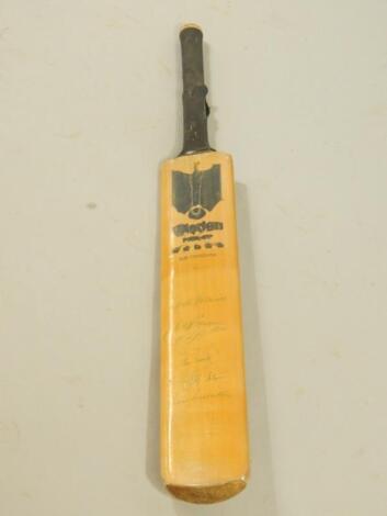 A Wisden cricket bat with numerous autographs