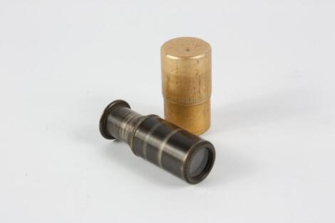 A miniature telescope in metal case.