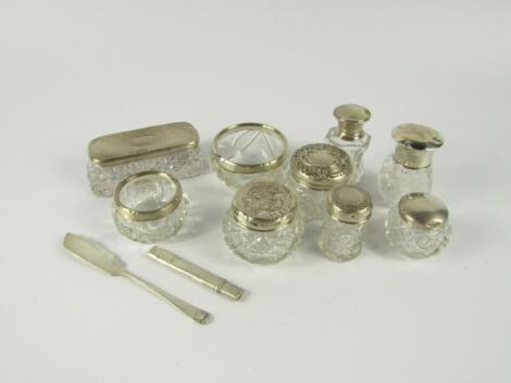 A collection of cut glass toilet jars and scent bottles