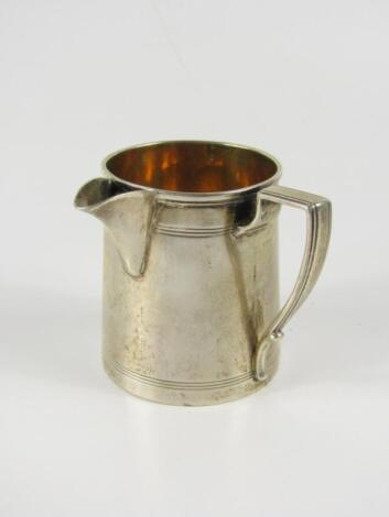 A 19thC white metal tapered cylindrical jug