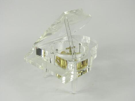 A crystal cased music box modelled as a grand piano