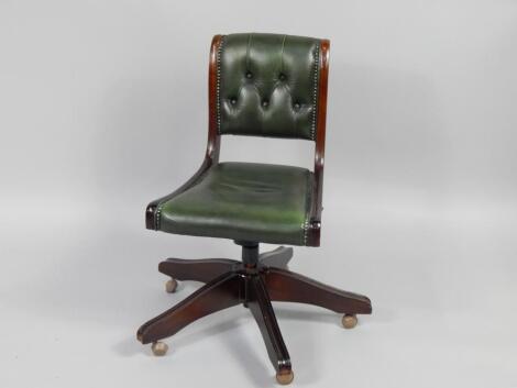 A mahogany and button upholstered green leather office swivel chair.