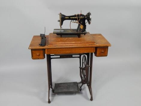 A Singer oak and cast iron treadle sewing table